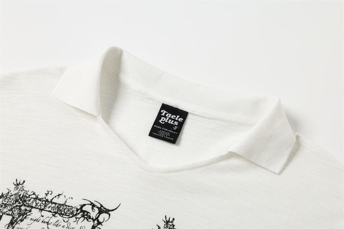 Close-up of white polo collar and upper chest with printed gothic graphic