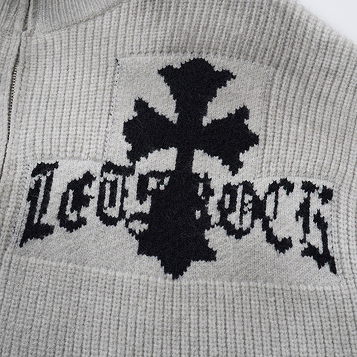 Close-up of the gray knit chest panel showing a black gothic cross and stylized lettering