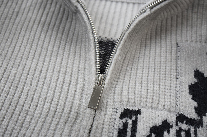 Close-up of the silver zipper opening on the gray ribbed knit sweater jacket