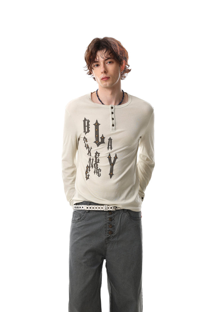 Cream gothic graphic Henley tee worn by model, front view with long sleeves