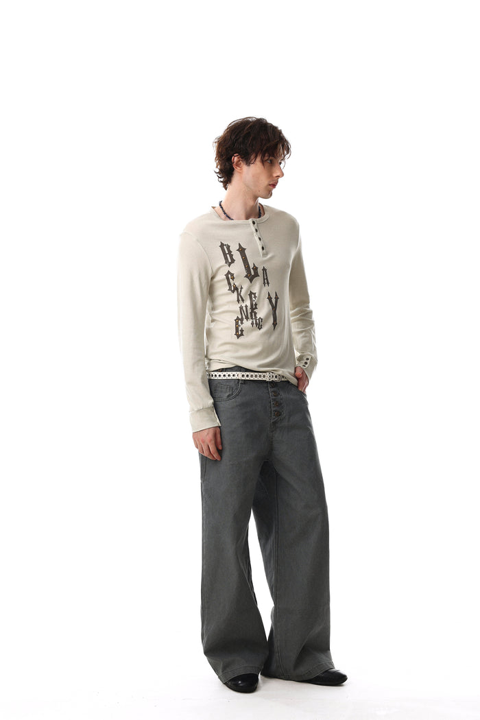 Cream gothic graphic Henley tee worn by model, angled side view