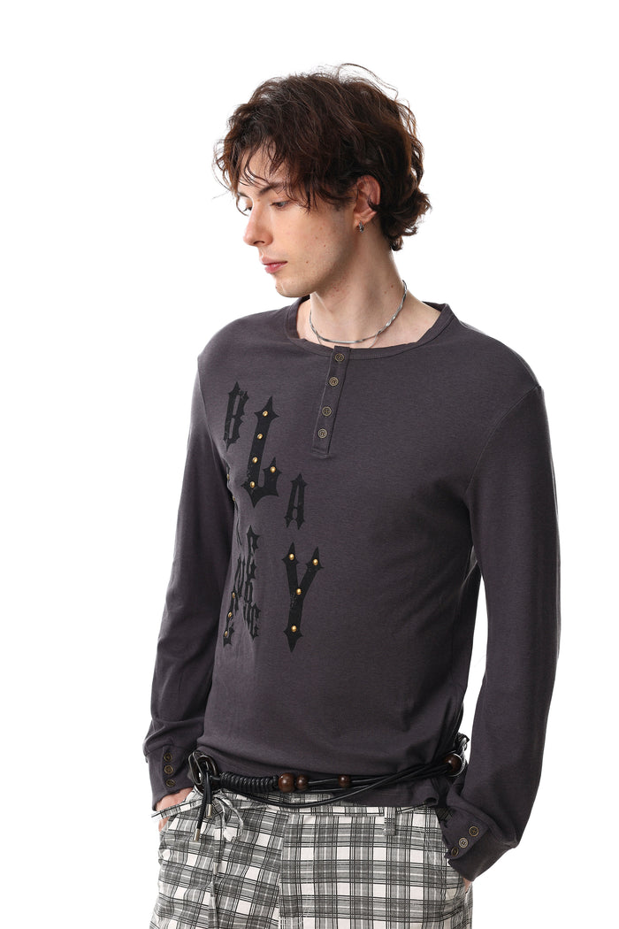 Dark charcoal gothic graphic Henley tee worn by model, angled front view