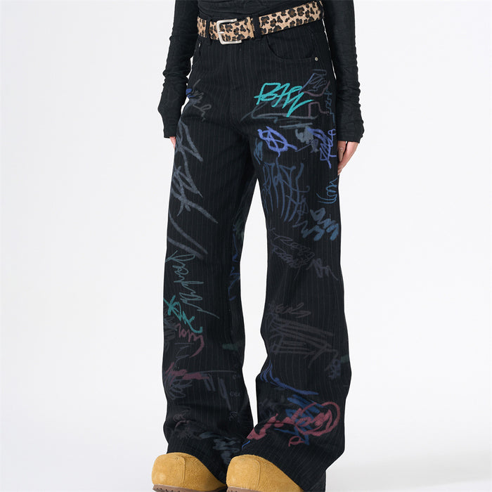 Front view of black pinstripe wide-leg jeans with graffiti print and leopard belt