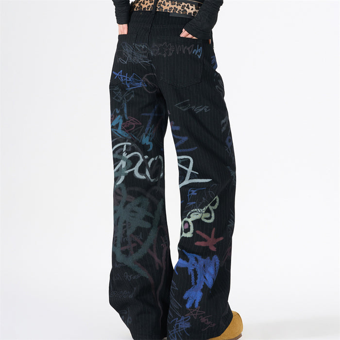 Back view of black pinstripe wide-leg jeans with multicolor graffiti print