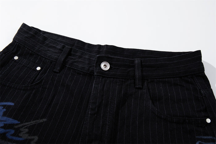 Close-up of black pinstripe jeans waistband with button and belt loops