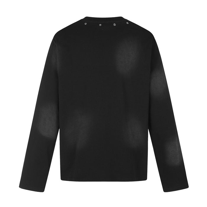 Back view of a plain black long-sleeve crew neck shirt with metal studs around the collar