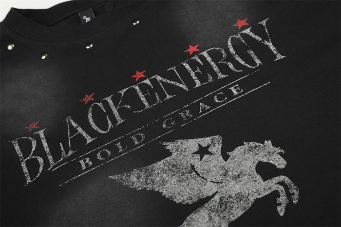 Close-up of black shirt chest showing distressed text, red stars, and a silver Pegasus graphic