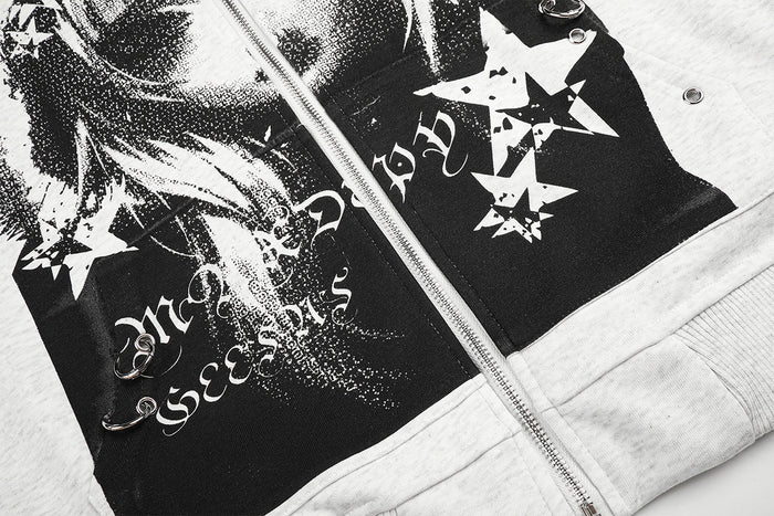 Close-up of black-and-white anime-style graphic panels with star motifs and lettering on the hoodie front