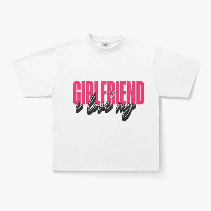 The I Love My Girlfriend Oversized Graphic Print T-Shirt is a comfy heavyweight cotton streetwear tee with bold pink GIRLFRIEND text and black "i love my" script with a heart accent—perfect for stylish everyday wear.