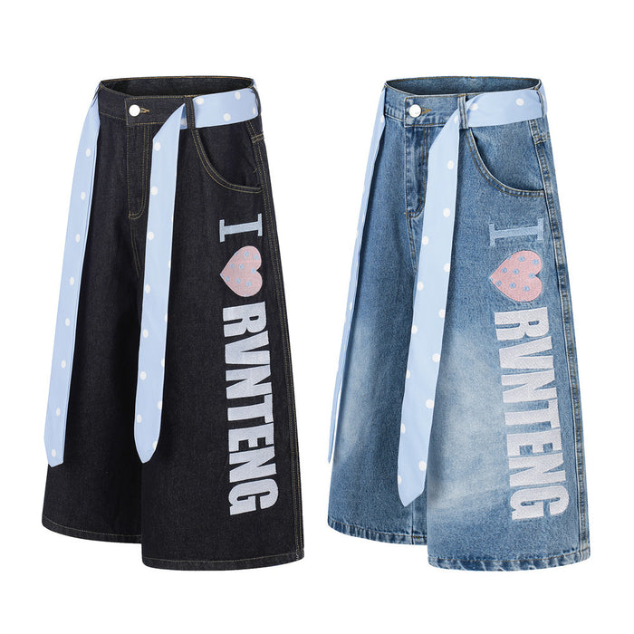 Wide-leg denim shorts in black and light wash blue with polka dot tie belt and front letter print