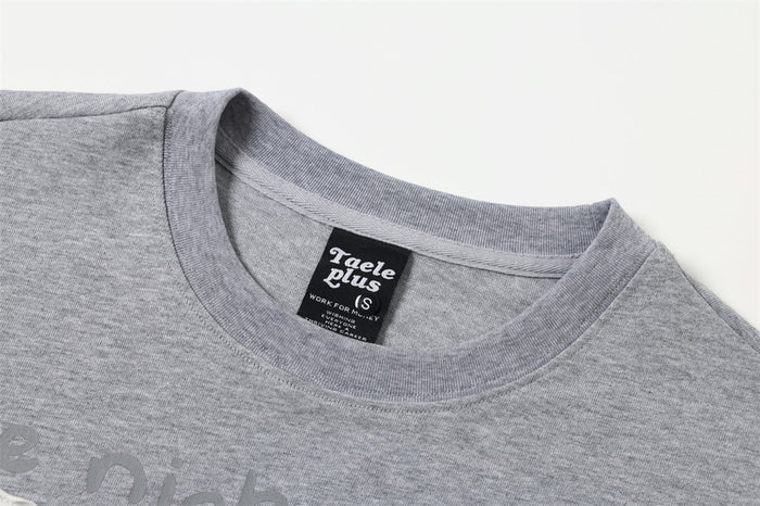 Close-up of gray crewneck collar on a graphic long sleeve tee