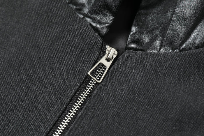 Close-up of silver front zipper on black jacket with textured woven fabric and faux leather hood
