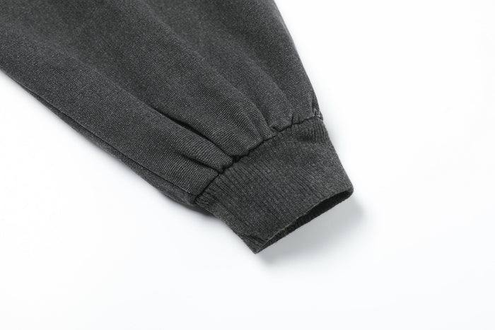 Close-up of black jacket sleeve cuff with ribbed knit trim