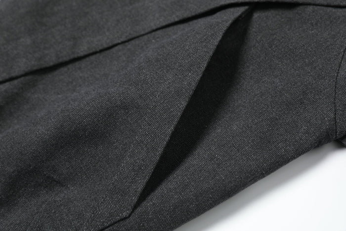 Close-up of black woven jacket fabric with diagonal seam detail