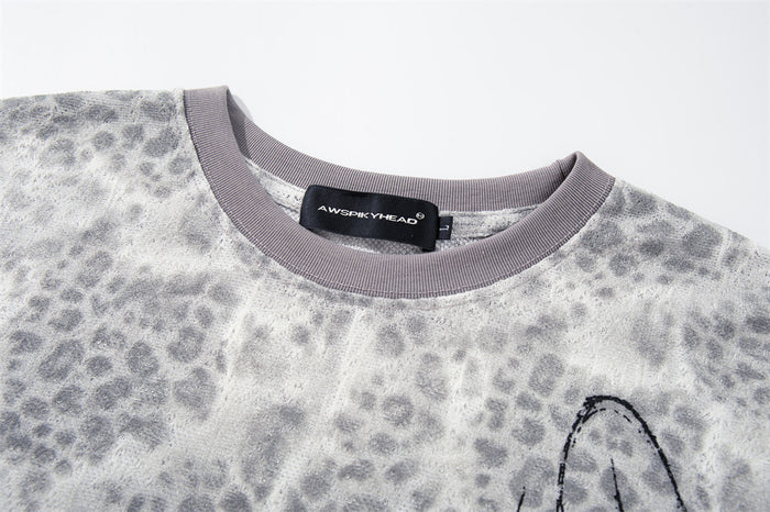 Close-up of crew neck collar and leopard print fabric