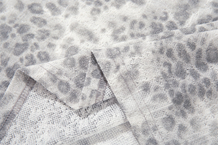 Close-up of leopard print fabric texture and stitching seam