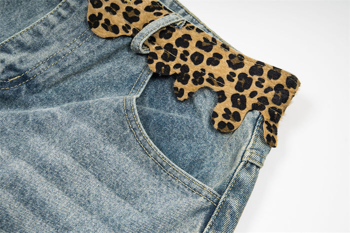 Side close-up of light wash denim shorts with leopard print waistband and pocket