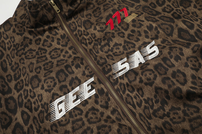 Close-up of leopard print jacket front showing gold zipper, red 777 embroidery and white GEE 545 graphics