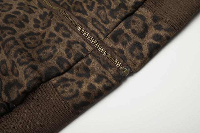Close-up of the leopard print bomber jacket zipper and ribbed brown hem trim
