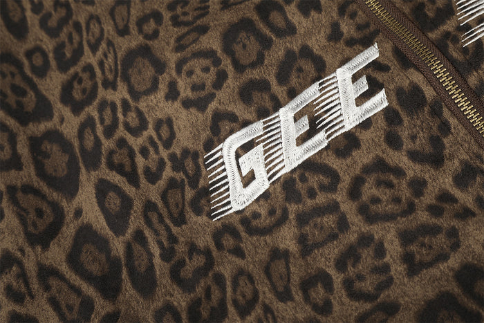 Close-up of white GEE embroidery against the brown leopard print jacket front