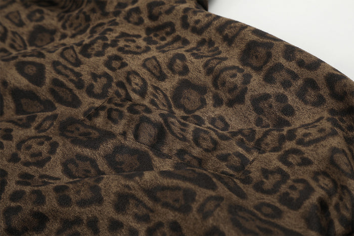 Close-up of brown leopard print jacket fabric showing a stitched shoulder seam and textured pattern