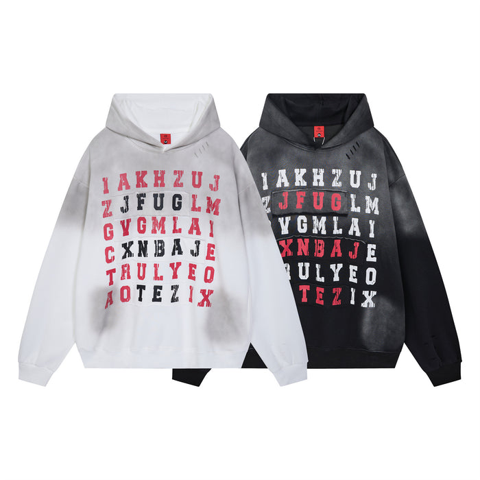 Front view of white and black oversized hoodies featuring multicolor distressed letter grid prints