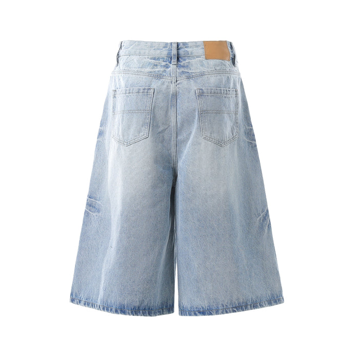 Light wash denim shorts back view with patch pockets and tan waistband label