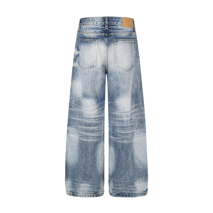 Back view of light blue washed wide-leg jeans with two patch pockets and horizontal fading