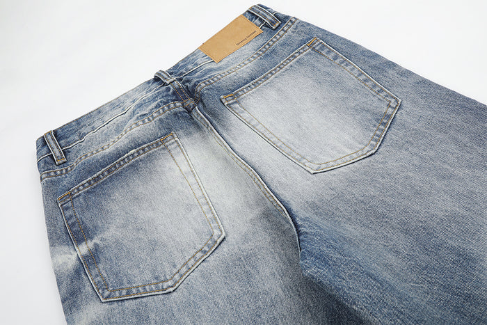 Close-up of the jeans back showing two patch pockets, contrast stitching and a tan waistband label