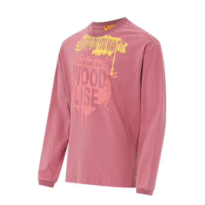 Angled front view of a pink long sleeve tee with yellow and pink dripping graffiti text graphic