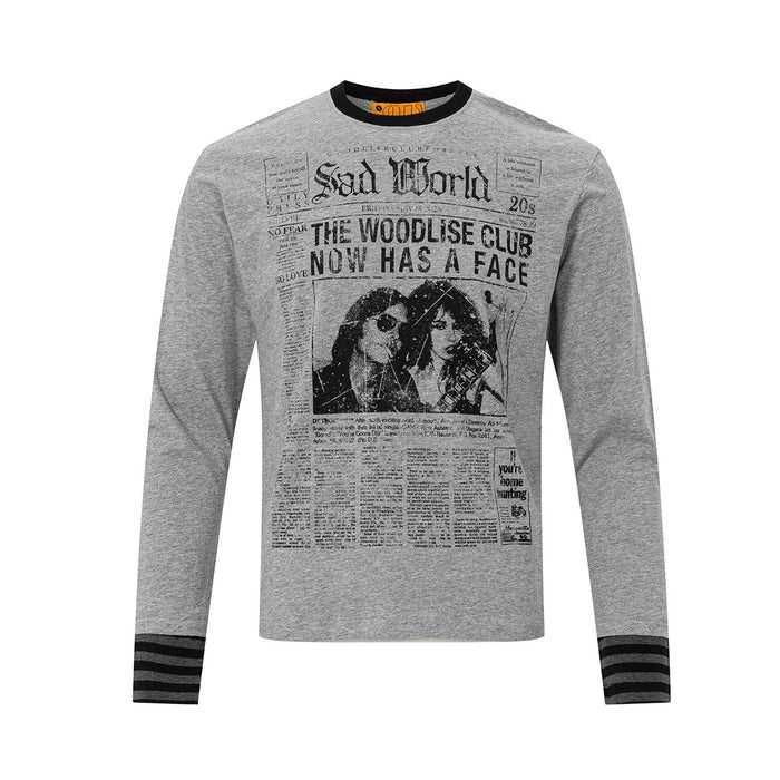 Front view of gray long sleeve shirt with black newspaper graphic and black-and-gray striped cuffs