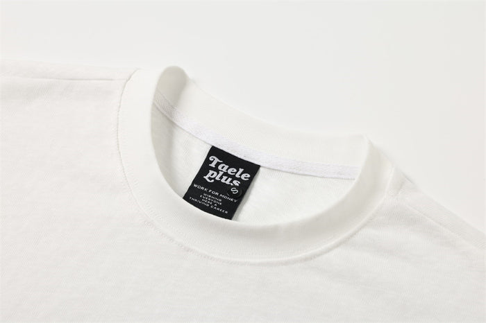 Close-up of white crew neck collar and brand label on long sleeve T-shirt