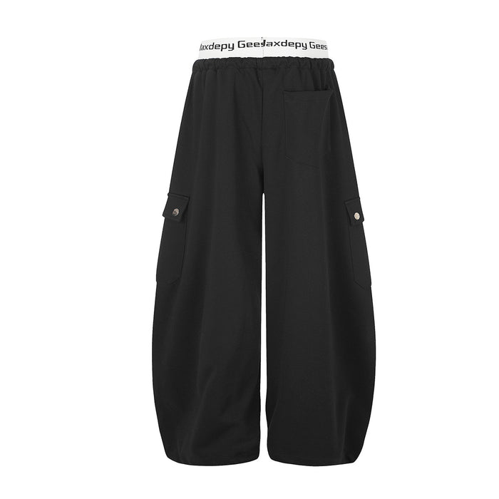 Back view of black wide-leg cargo sweatpants with rear pocket and flap cargo pockets