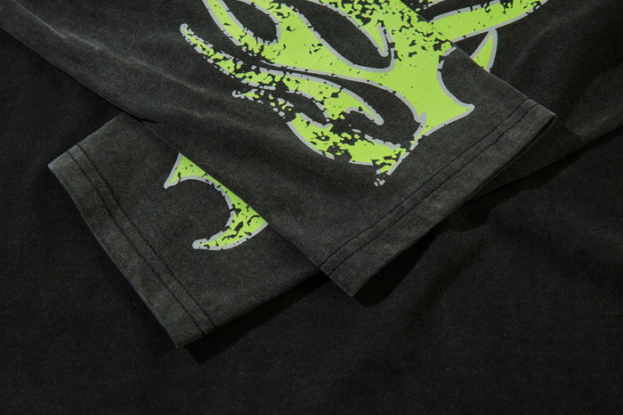 Close-up of black sleeve with neon green flame graphic and stitched cuff
