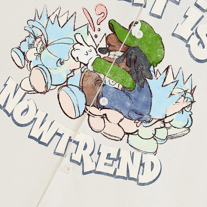 Close-up of cream shirt front graphic with cartoon figure and the words What Is Nowtrend