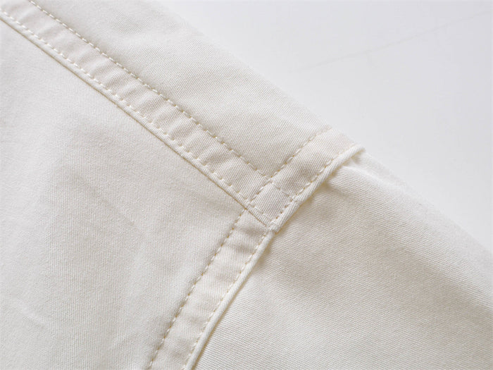 Close-up of cream shirt shoulder seam and topstitching