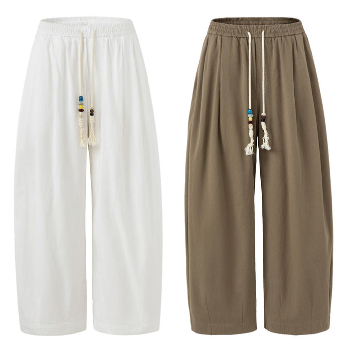 Front view of wide-leg drawstring pants in white and taupe brown with beaded rope ties