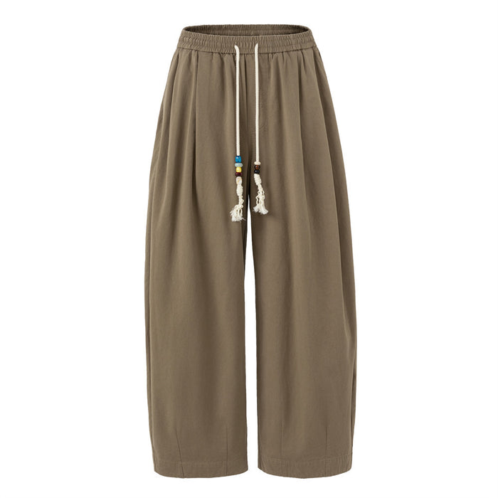 Front view of taupe brown wide-leg pants with an elastic drawstring waist and beaded ties