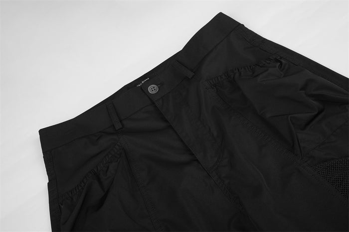 Close-up of black cargo pants waistband and front seam details