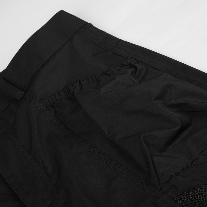 Close-up of black cargo pants front panel with stitched seam details