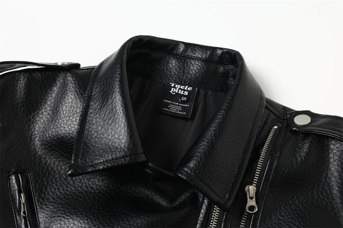 Close-up of black moto jacket collar, shoulder snap, and asymmetric front zipper