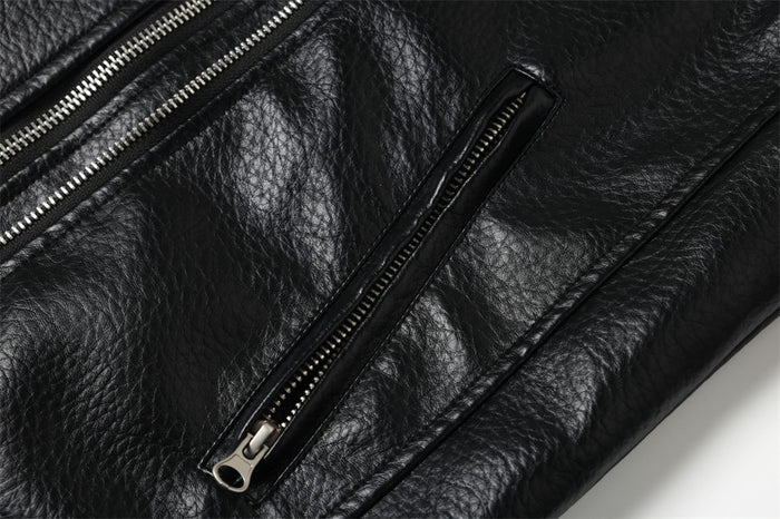Close-up of black jacket chest pocket zipper and front panel stitching
