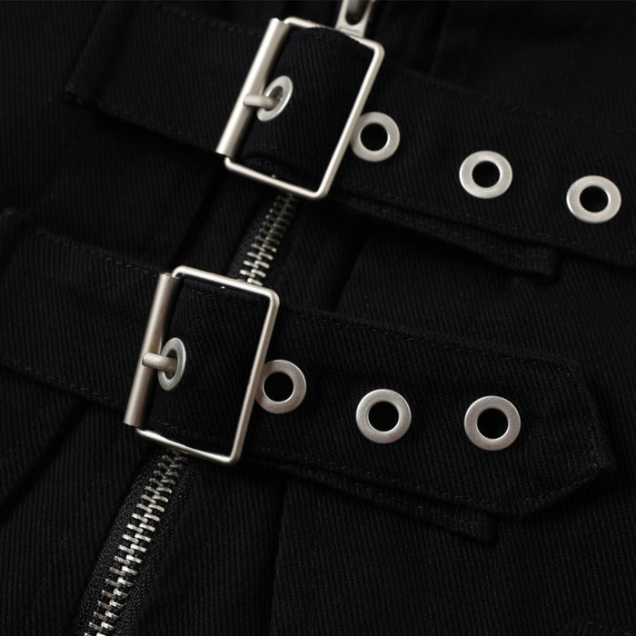 Close-up of two metal buckle straps with eyelets across the black jacket front beside the zipper teeth