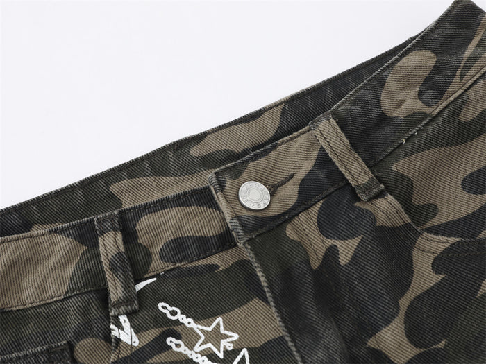 Close-up of the camouflage jeans waistband with belt loops, button closure, and star print