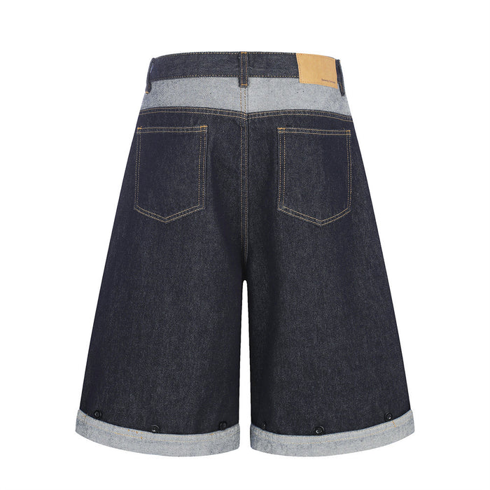 Back view of wide-leg denim shorts with patchwork waistband, back pockets, and rolled cuffs