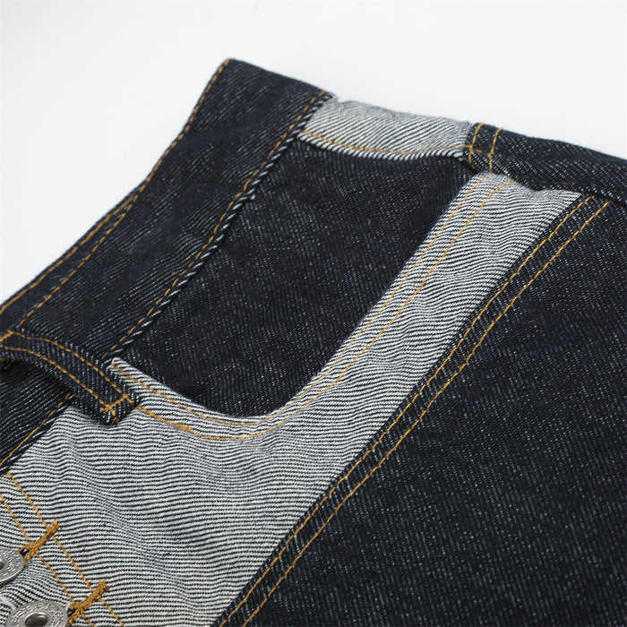 Close-up of back waistband and patchwork yoke on dark denim shorts