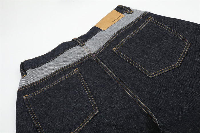 Back view of denim shorts showing patchwork waistband and two back pockets