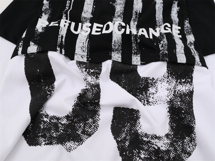 Close-up of the front colorblock seam with REFUSED CHANGE lettering and distressed black 09 graphic across the white panel