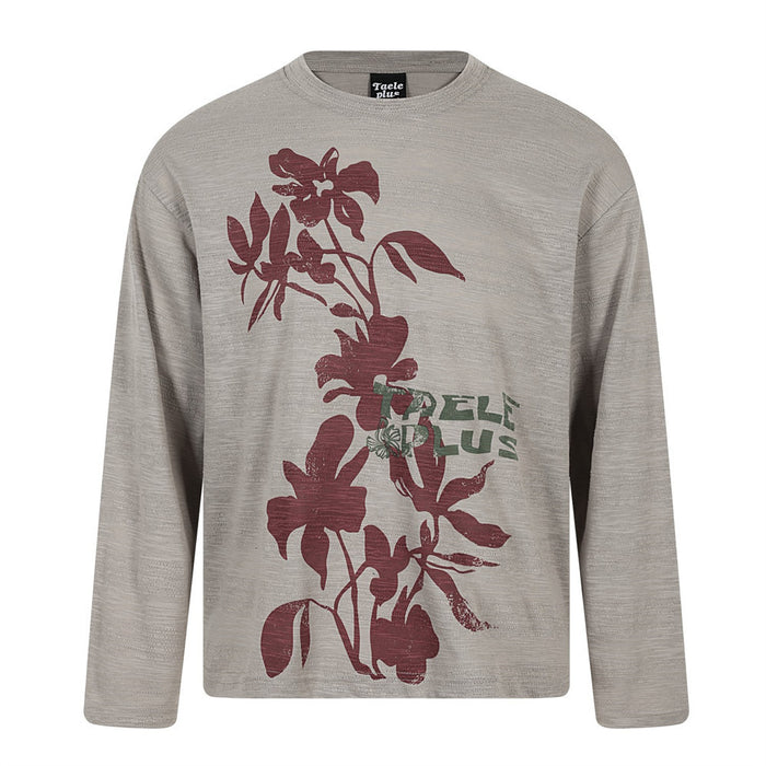 Front view of a taupe oversized long sleeve tee with burgundy floral graphics and green lettering