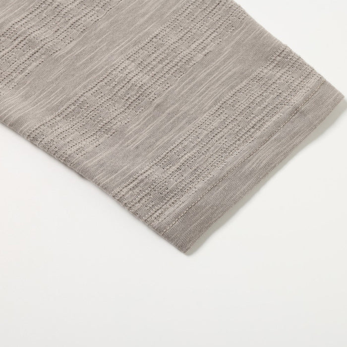 Close-up of the taupe tee sleeve hem showing fine horizontal knit texture